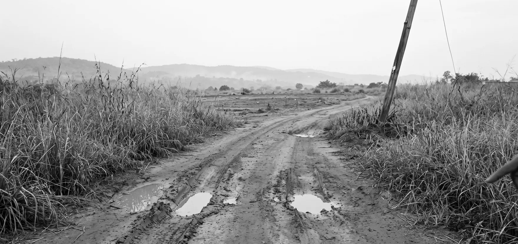 Red laterite access track leading to the parcel